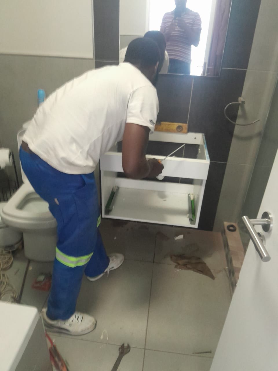 Plumber installing a bathroom vanity unit